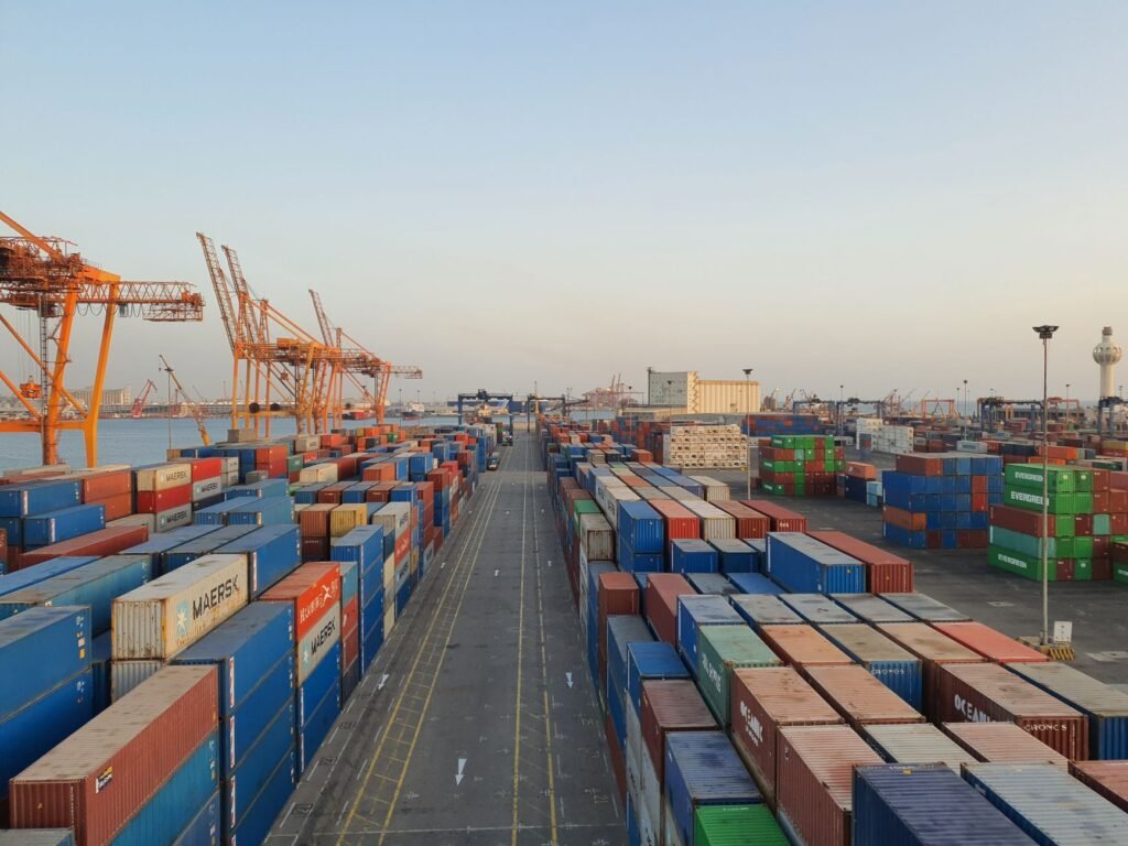 Stacked shipping containers at a freight port, illustrating EU export documentation