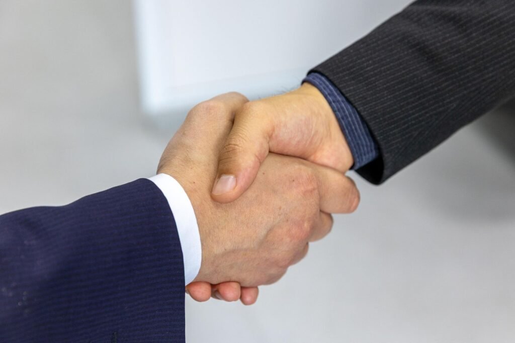 Business handshake, illustrating appointing an overseas distributor